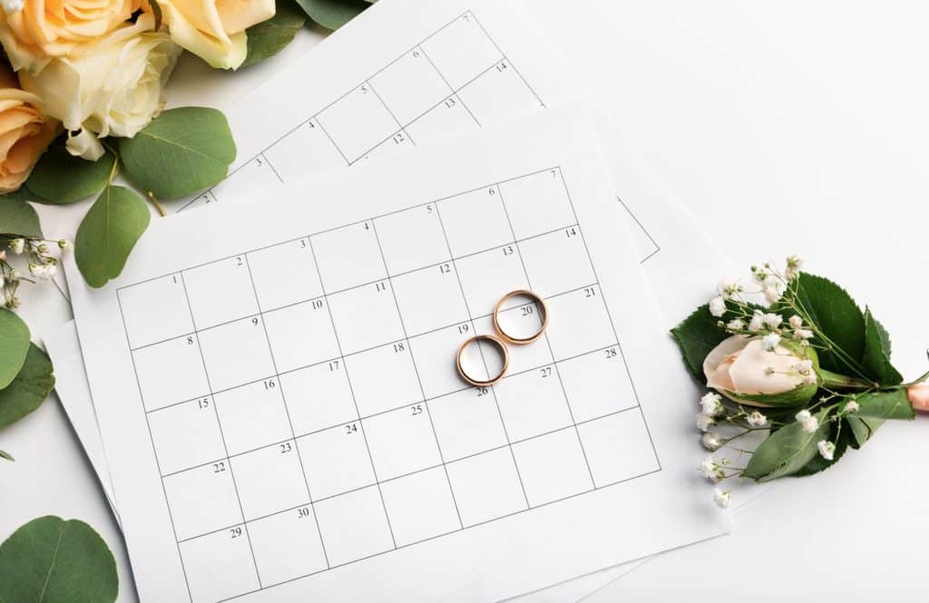 Planning wedding date in calendar, gold rings