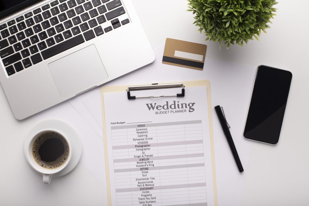Wedding Planning text written on a clipboard, credit card
