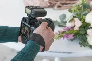 Wedding Photographer Capturing Close-Up Shot of Wedding Details