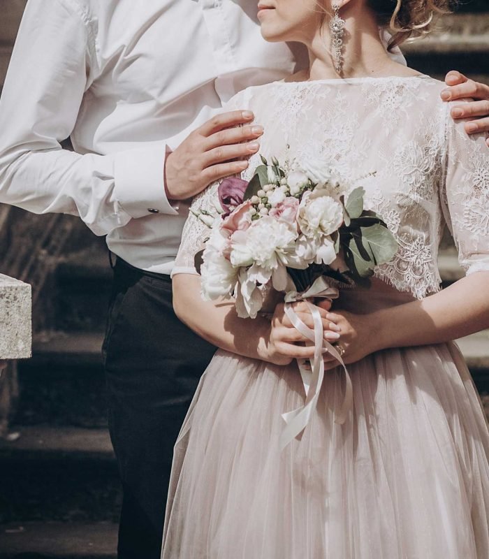 stylish wedding couple with bouquet