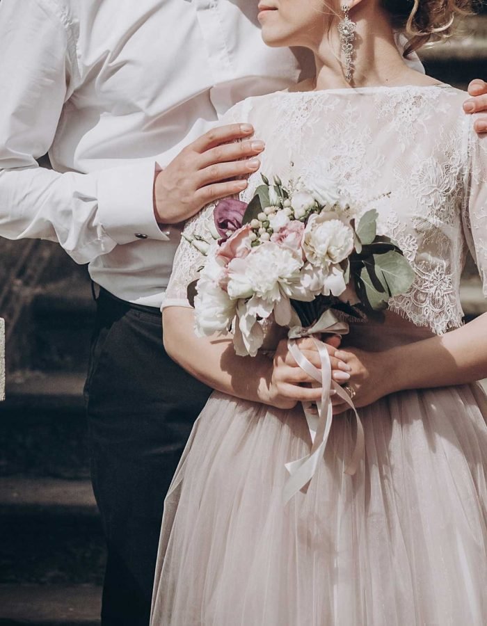 stylish wedding couple with bouquet