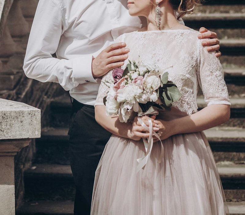 stylish wedding couple with bouquet